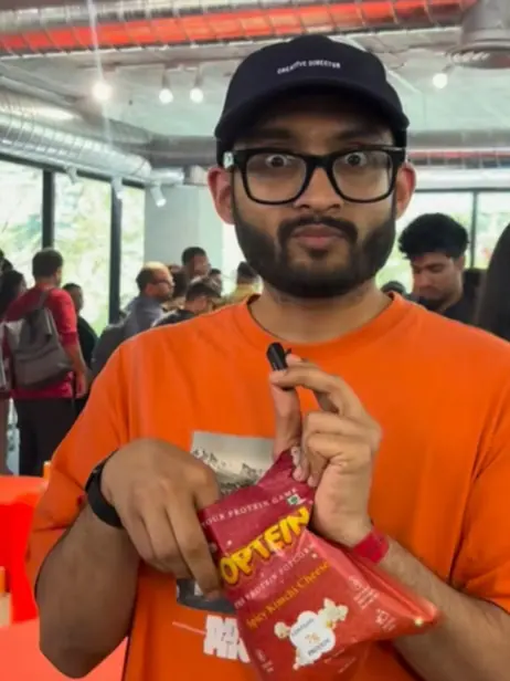 Fan opening a pack of Spicy Kimchi Cheese Poptein