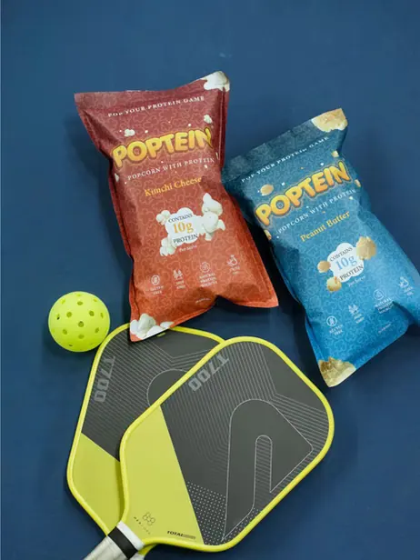Poptein packs beside pickleball paddles
